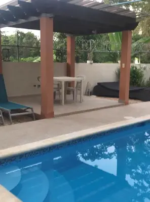 a patio with a table and a swimming pool at Apartamento CGM de 1 habitación in La Romana