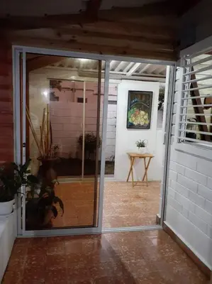 a glass door leading to a room with a table at Apartamento Hogareño in Jarabacoa