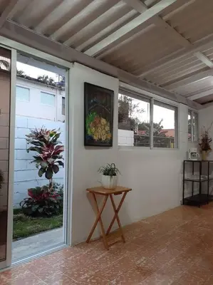 a screened in porch with a table and windows at Apartamento Hogareño in Jarabacoa
