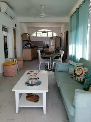 a living room with a couch and a table at Indy's Best Bay FrontView in Samana. in Santa Bárbara de Samaná