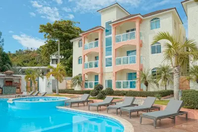 a villa with a swimming pool and a resort at Ria Hotel in San Felipe de Puerto Plata