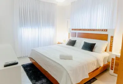 a bedroom with a bed with a laptop on it at Modern apartment in Santiago de Los caballeros in Santiago de los Caballeros