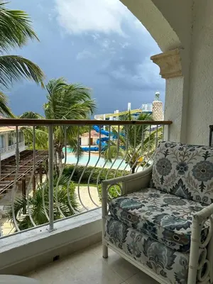 a balcony with a chair and a view of the beach at Hotel Palmera Bayahibe in Bayahibe
