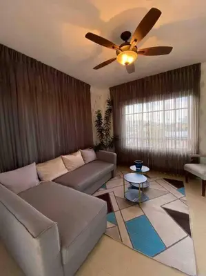 a living room with a couch and a ceiling fan at Beautiful Penthouse in La Vega, RD in Concepción de La Vega