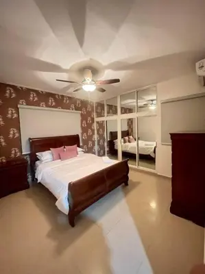 a bedroom with a bed and a ceiling fan at Beautiful Penthouse in La Vega, RD in Concepción de La Vega