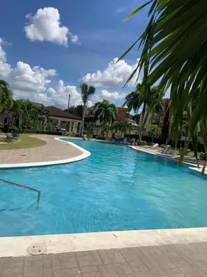a large pool with blue water in a resort at Sweet Home in Santiago de los Caballeros