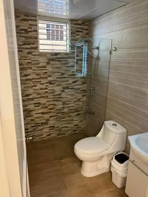 a bathroom with a toilet and a glass shower at Sweet Home in Santiago de los Caballeros