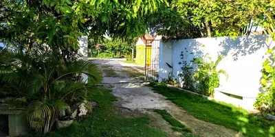 a path in a yard with a white fence and trees at El Conde del Macao in Salado
