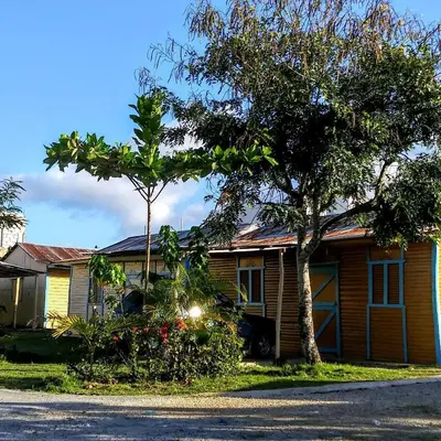 a house with two trees in front of it at El Conde del Macao in Salado