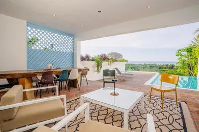 an open living room with a table and chairs at Piece of Paradise in Las Terrenas