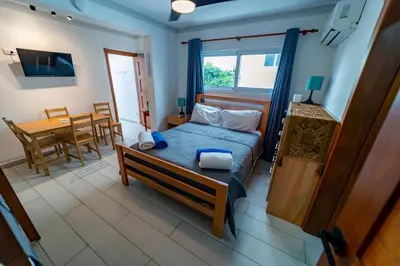 a bedroom with a bed and a table and a dining room at Studio Beachfront Kite Beach in Cabarete