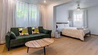 a living room with a couch and a bed at Kite Beach Oceanfront Two Bedroom Patio and Garden in Cabarete
