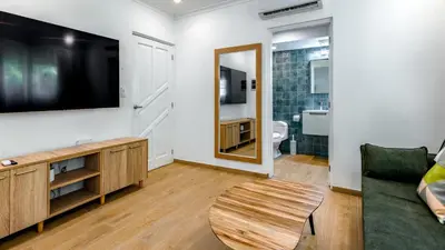 a living room with a tv and a couch at Kite Beach Oceanfront Two Bedroom Patio and Garden in Cabarete
