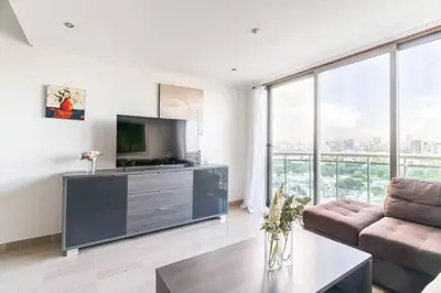 a living room with a television and a couch at Luxurious 2BDR condo located in Prestigious Tower. in Santo Domingo