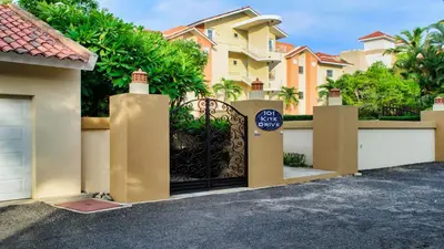 a gate in front of a house with houses at Ocean Dream Artist Loft 1st See Line in Cabarete
