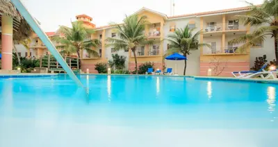 a swimming pool in front of a hotel at Ocean Dream 3d floor studio w/balcony in Cabarete