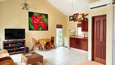a living room with a table and a kitchen at Ocean Dream Studios Cabarete in Cabarete