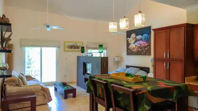 a living room with a table and a couch at Ocean Dream Studios Cabarete in Cabarete
