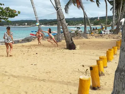 a group of girls playing on the beach at Costarena Beach Hotel in Las Terrenas