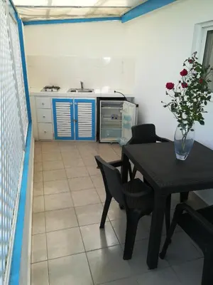 a kitchen with a table with a vase of flowers at Costarena Beach Hotel in Las Terrenas