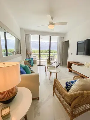 a living room with a couch and a tv at Xeliter Cana Rock Punta Cana in Punta Cana