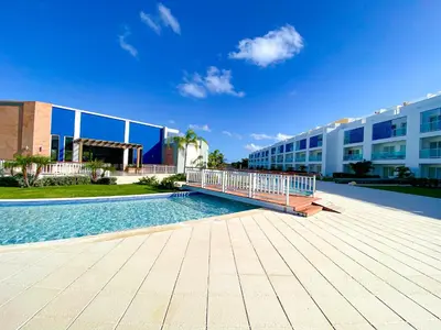 a swimming pool in front of a building at Xeliter Cana Rock Punta Cana in Punta Cana