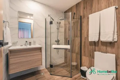 a bathroom with a shower and a sink and a toilet at Chic Fully Serviced Apartment at Regatta Living II - 705 in Los Prados