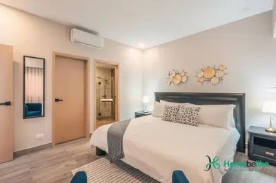 a bedroom with a large white bed in a room at Chic Fully Serviced Apartment at Regatta Living II - 705 in Los Prados