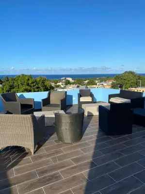 a group of chairs and tables on a patio at RESIDENCIAL DOÑA GLORIA in San Felipe de Puerto Plata