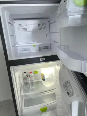 an open refrigerator with drinks and bottles of water at Residencial christall ap 2-A in Santiago de los Caballeros