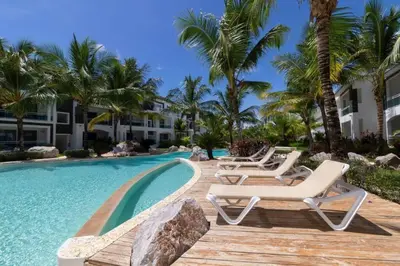 a swimming pool with lounge chairs and palm trees at Sunny garden in La Laguna