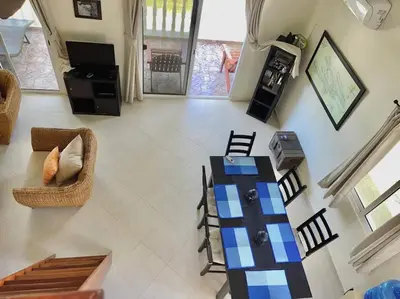 a living room with a table and chairs at The Cove Apartment Second Floor 5C in Santa Bárbara de Samaná