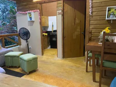 a kitchen with a table and a fan in a room at Villas Don Che, 2 villas in Jarabacoa
