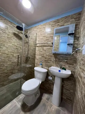 a bathroom with a toilet and a sink and a shower at Paulino in Santiago de los Caballeros