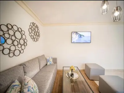a living room with a couch and a table at Fully Equipped 2br Apt-dt5mins To The Beach in Sosúa