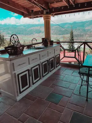 an outdoor kitchen with a view of the mountains at Villa paloma in Constanza