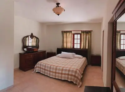 a bedroom with a bed and a mirror in it at Villa paloma in Constanza