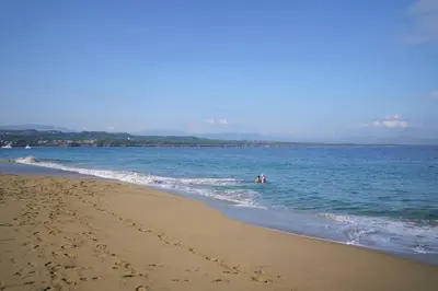 two people are in the water at the beach at Room #27 at Waterfront Playa Alicia in Sosúa
