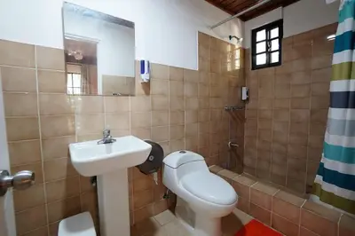 a bathroom with a sink and a toilet and a shower at Room #27 at Waterfront Playa Alicia in Sosúa