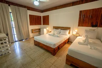 a bedroom with two beds and two lamps at Room #28 at Waterfront Playa Alicia in Sosúa