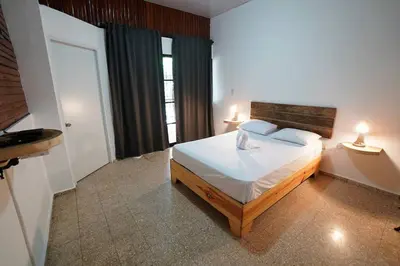 a bedroom with a bed with two lamps on it at Room #26 at Waterfront Playa Alicia in Sosúa