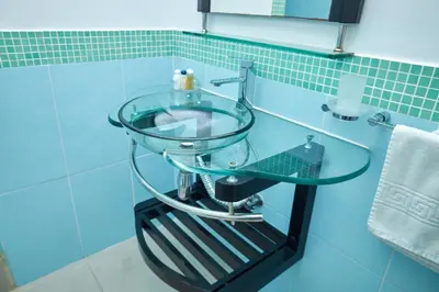 a glass sink in a bathroom with blue tiles at LA VlTA E' BELLA in Los Mameyes