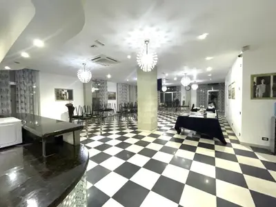 a lobby with a checkered floor and chandeliers at LA VlTA E' BELLA in Los Mameyes