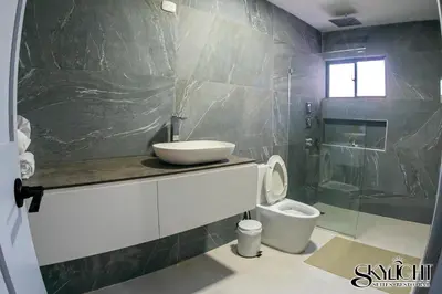 a bathroom with a sink and a toilet at Skylight Suites Hotel in San Felipe de Puerto Plata