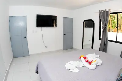 a bedroom with a bed with towels on it at Skylight Suites Hotel in San Felipe de Puerto Plata