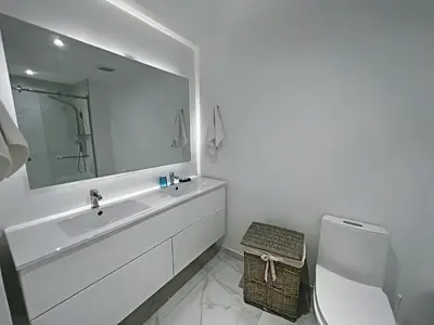 a bathroom with a sink and a toilet and a mirror at Hermoso Apartamento Cana Rock Star Acceso Directo a la Piscina C-105, C-106, B-102 y B-104 in Punta Cana