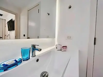 a bathroom with a sink and a mirror at Hermoso Apartamento Cana Rock Star Acceso Directo a la Piscina C-105, C-106, B-102 y B-104 in Punta Cana