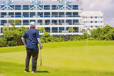 a man is standing on a golf course at Hermoso Apartamento Cana Rock Star Acceso Directo a la Piscina C-105, C-106, B-102 y B-104 in Punta Cana