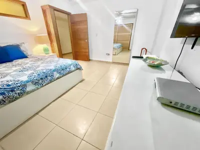 a bedroom with a bed and a counter with a sink at 707 Marbella 2bedroom Beachfrom Apt in San Pedro de Macorís