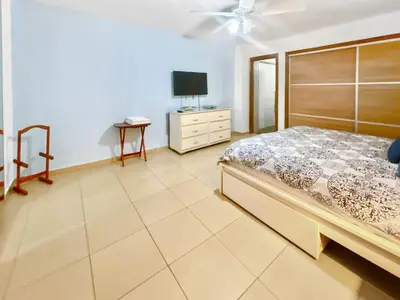 a bedroom with a bed and a tv on a dresser at 707 Marbella 2bedroom Beachfrom Apt in San Pedro de Macorís